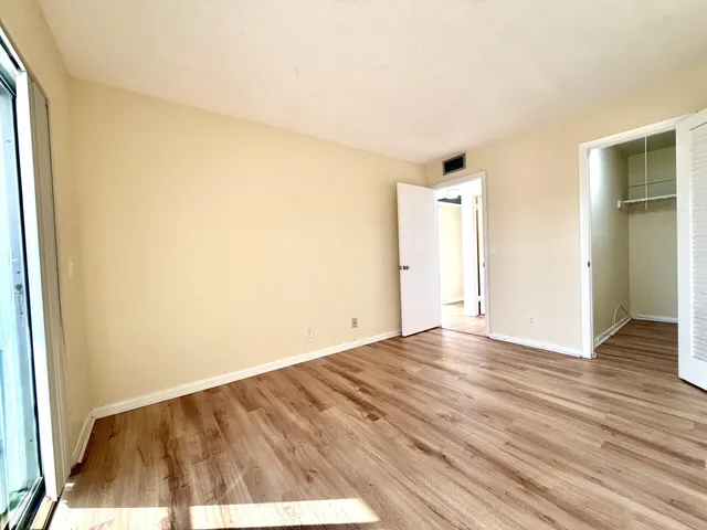 a view of an empty room and wooden floor