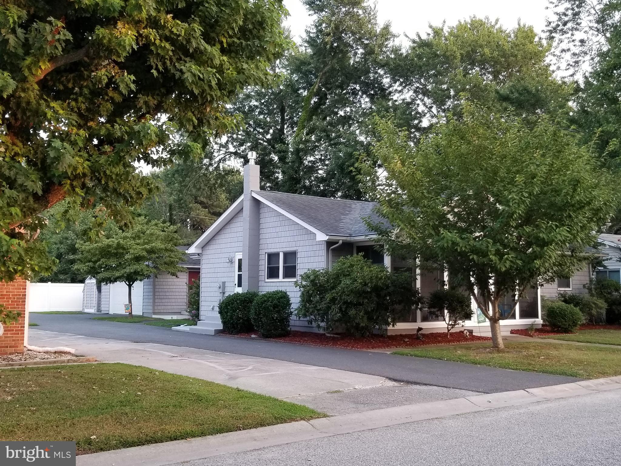 Asphalt drive with  detached 2 car garage