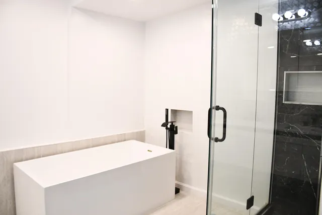 a bathroom with a bathtub and shower