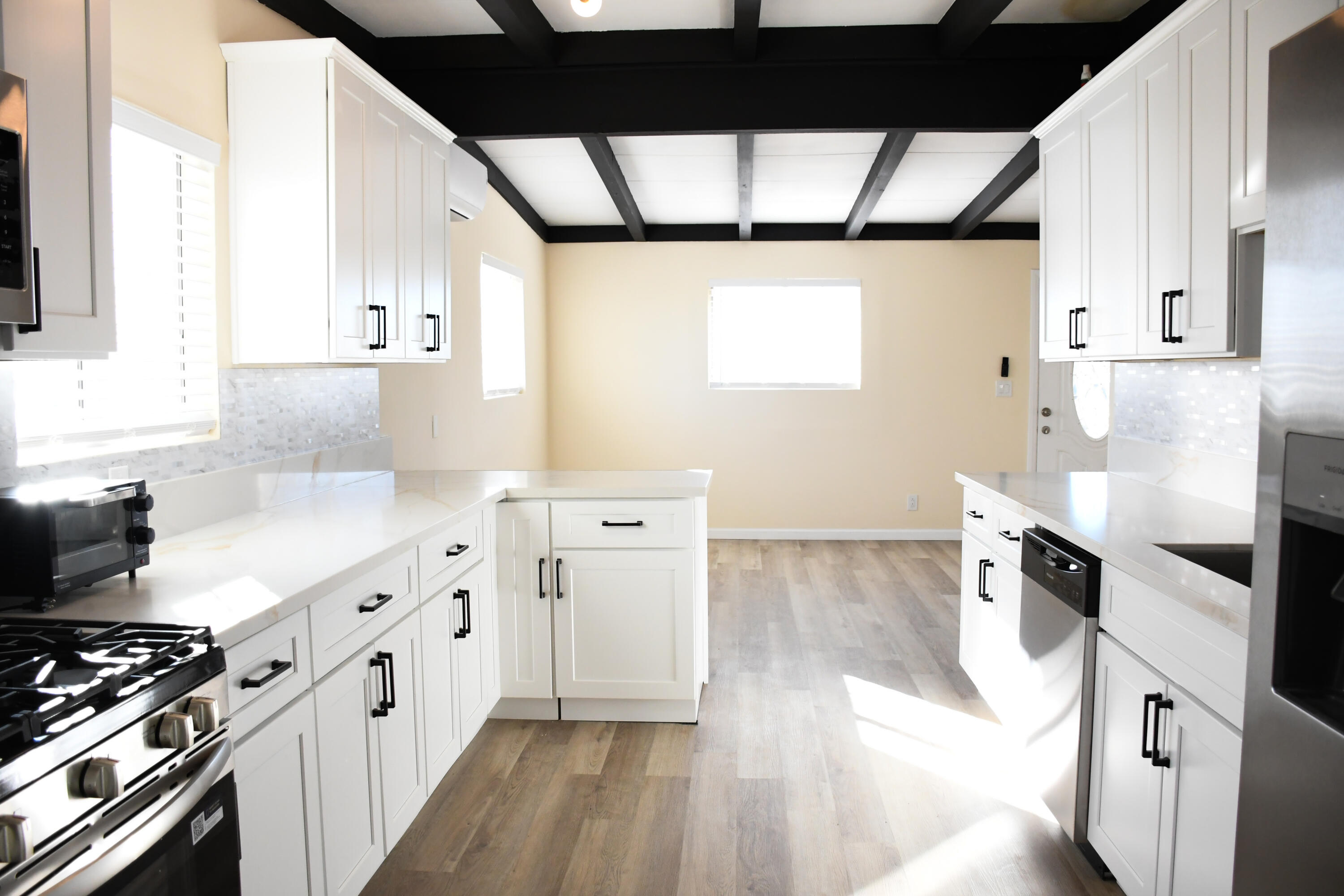 61576 Aberdeen Drive Joshua Tree, CA 92252 - Photo 2 of 31 a kitchen with granite countertop a stove a sink and a refrigerator