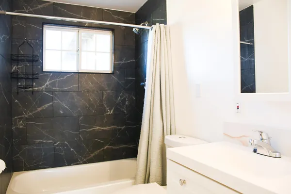 a bathroom with a bathtub and a sink