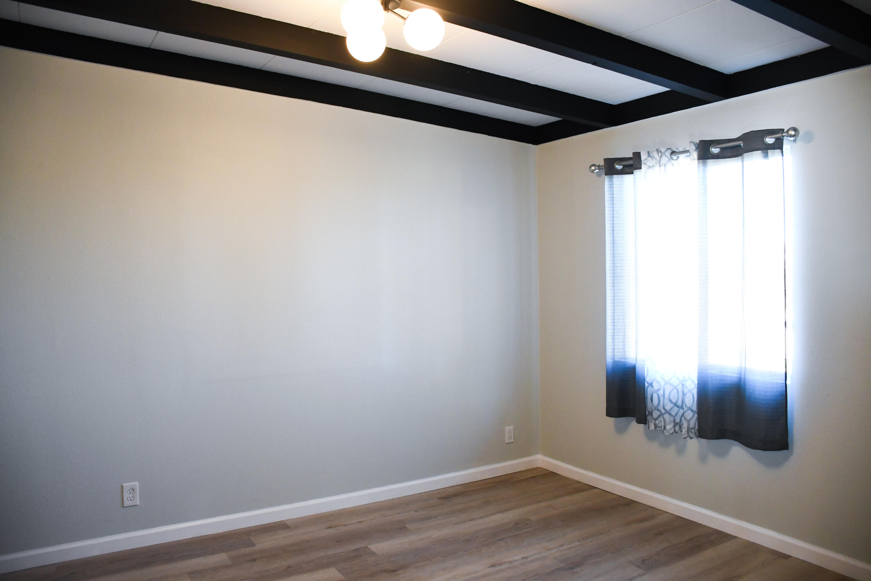 61576 Aberdeen Drive Joshua Tree, CA 92252 - Photo 23 of 31 a view of empty room with wooden floor and fan