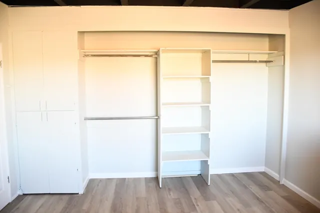 a view of a room with wooden floor