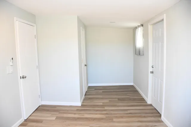 a view of a hallway with wooden floor