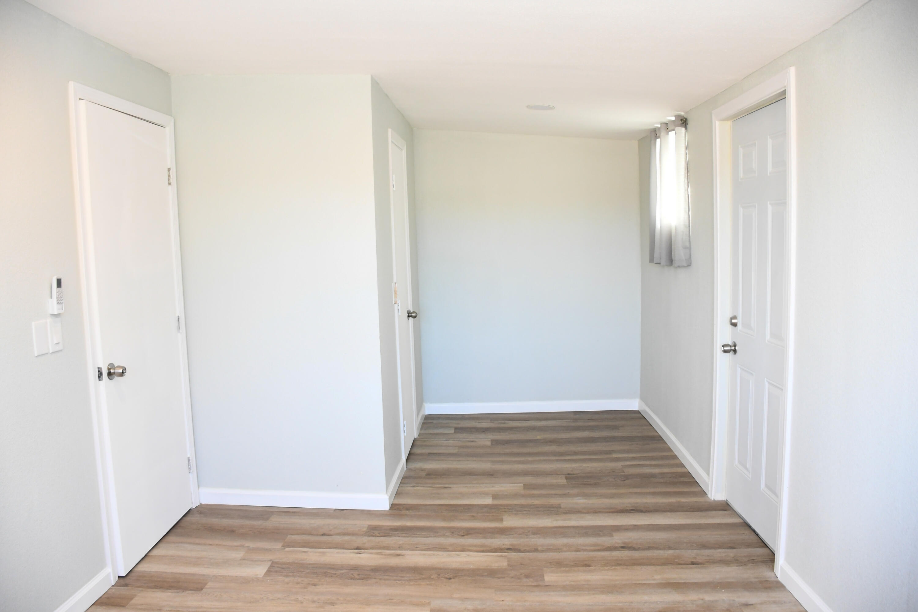 61576 Aberdeen Drive Joshua Tree, CA 92252 - Photo 26 of 31 a view of a hallway with wooden floor