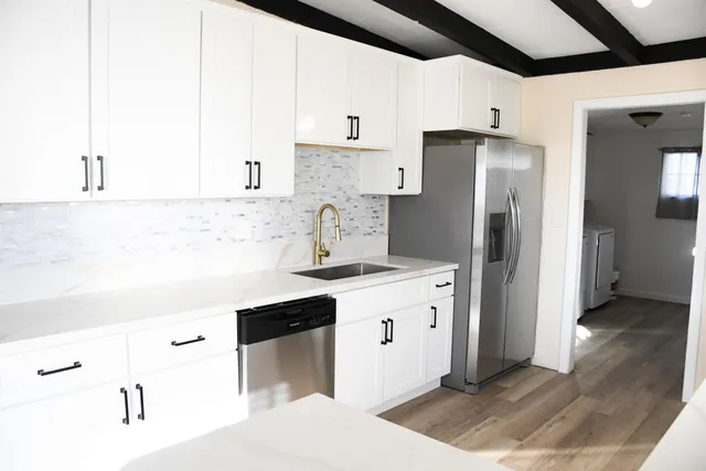 a kitchen with stainless steel appliances a refrigerator and a stove