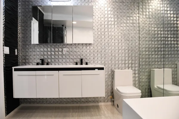 a bathroom with a sink a toilet and mirror