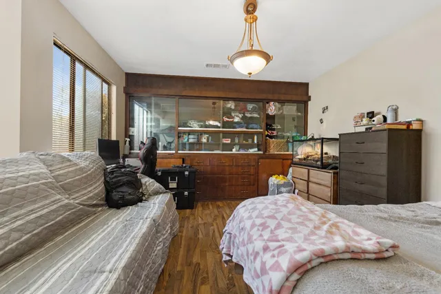 a bedroom with a bed and wooden floor