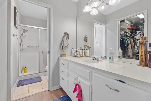 a spacious bathroom with a sink a mirror and a shower