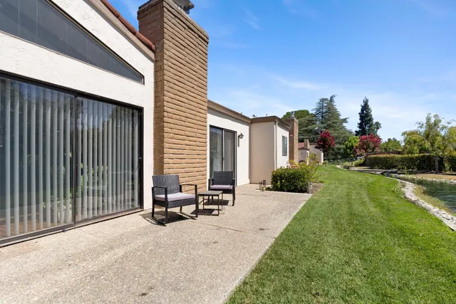 a view of a house with backyard and sitting area
