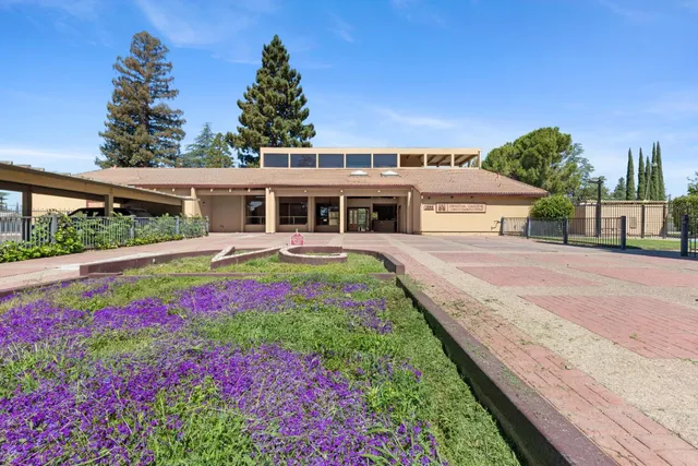 a view of a house with swimming pool and garden