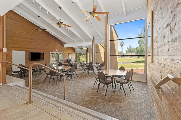 a dining room with furniture a floor to ceiling window and floor to ceiling windows