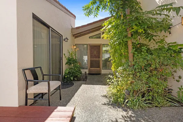a view of a house with backyard and sitting area