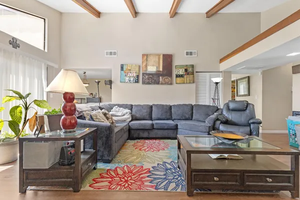 a living room with furniture and a lamp