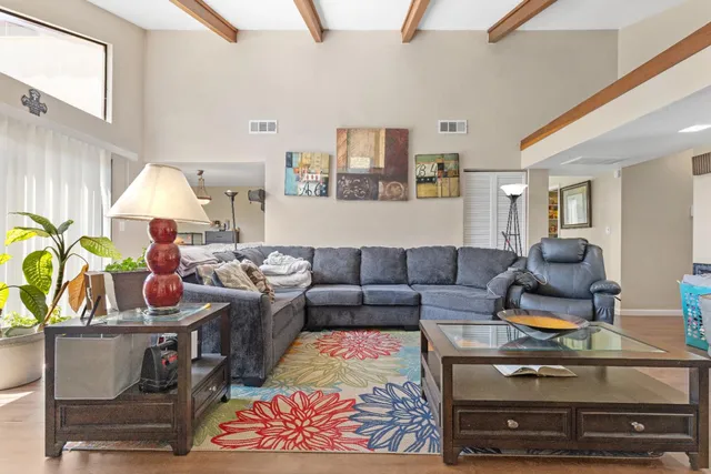 a living room with furniture and a lamp