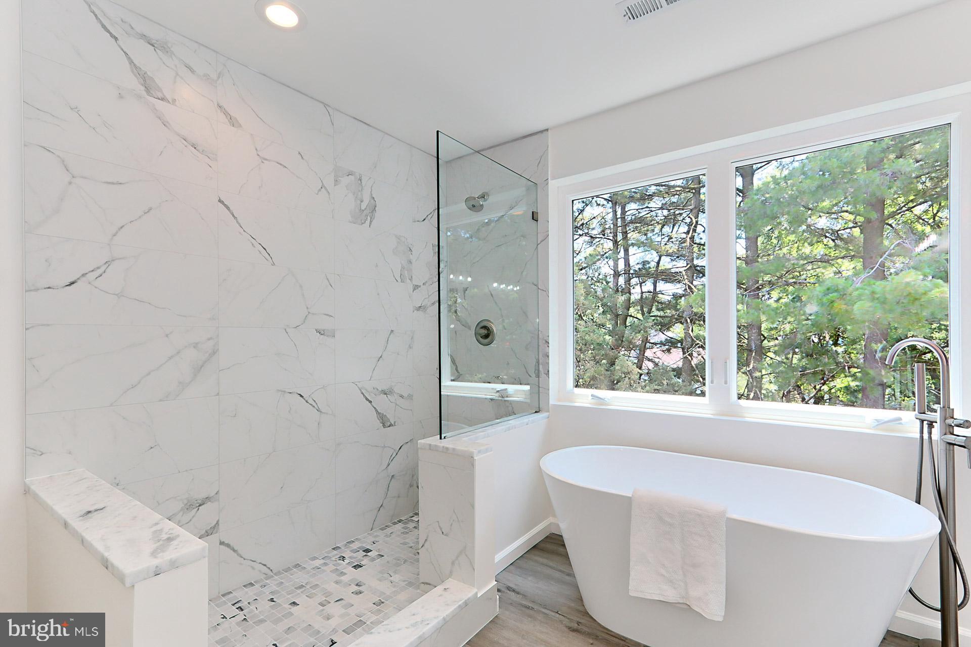 6400 Wayles Street Springfield, VA 22150 - Photo 18 of 46 a bath tub sitting in a bathroom next to a window