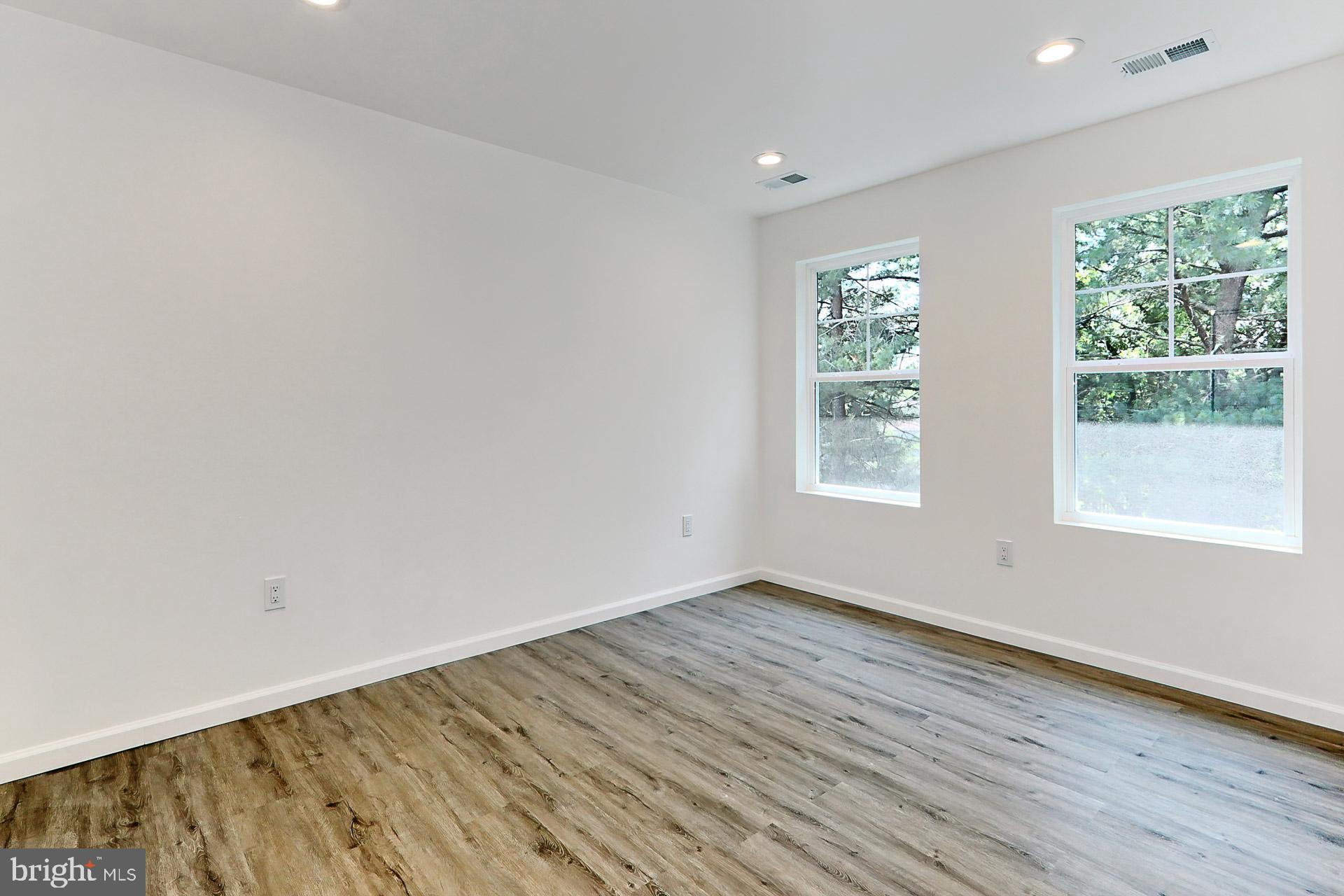 6400 Wayles Street Springfield, VA 22150 - Photo 20 of 46 a view of an empty room with wooden floor and a window