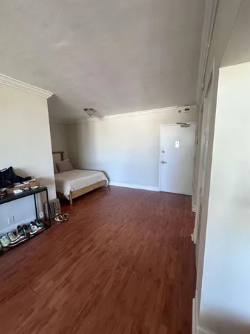 a room with wooden floor and gym equipment