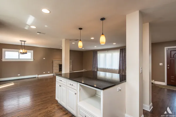 a kitchen with granite countertop a sink a counter space and stainless steel appliances