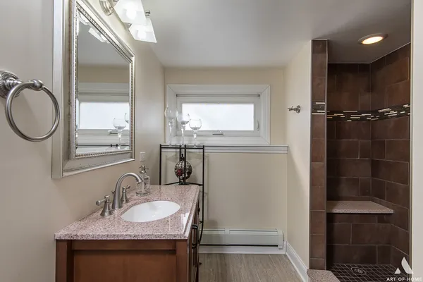 a bathroom with a sink a toilet and a mirror
