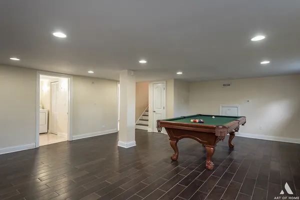 a room with wooden floor a table and chairs