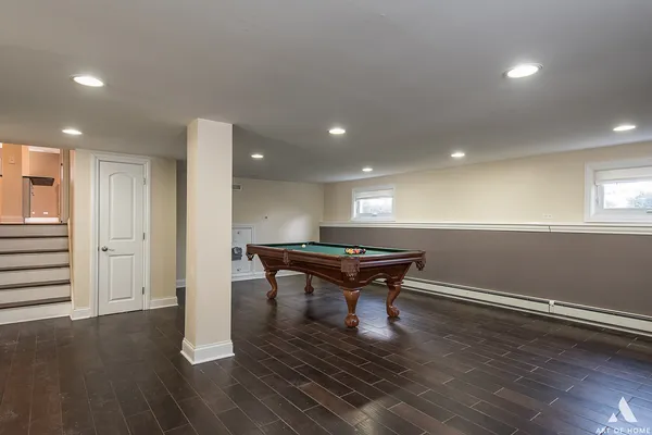 a room with wooden floor table and chairs