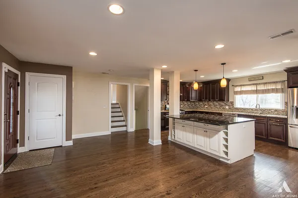 a kitchen with stainless steel appliances granite countertop a stove and a refrigerator