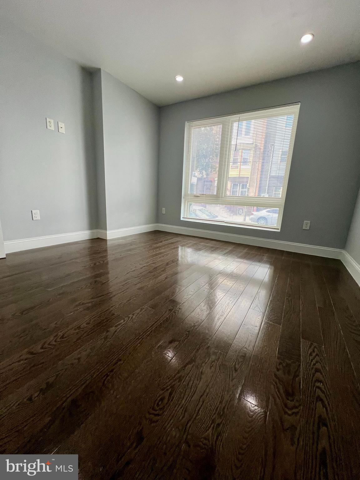 1703 South 22nd Street, Unit 1 Philadelphia, PA 19145 - Photo 12 of 27 an empty room with wooden floor and windows