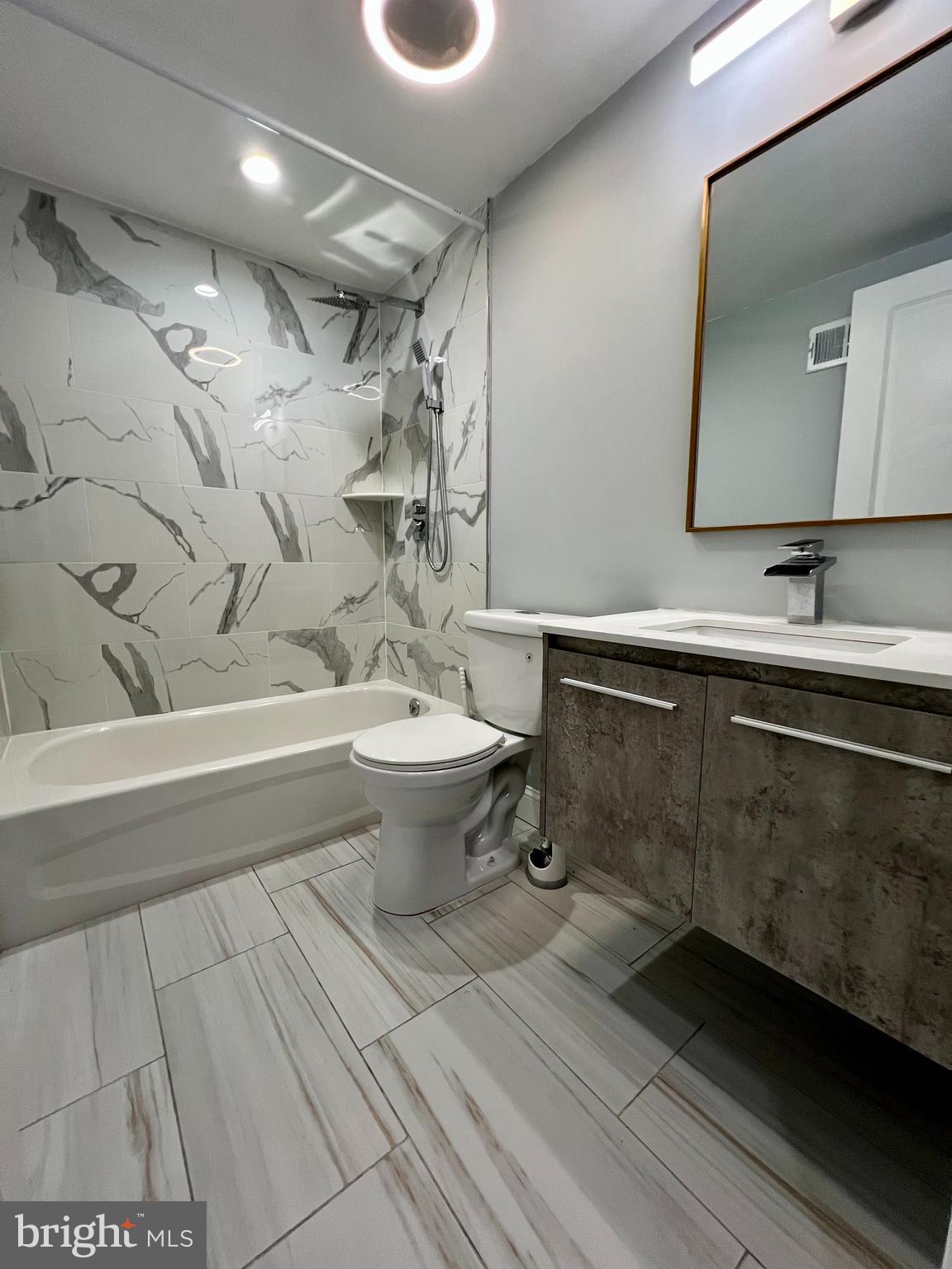 1703 South 22nd Street, Unit 1 Philadelphia, PA 19145 - Photo 14 of 27 a bathroom with a sink mirror toilet and bathtub