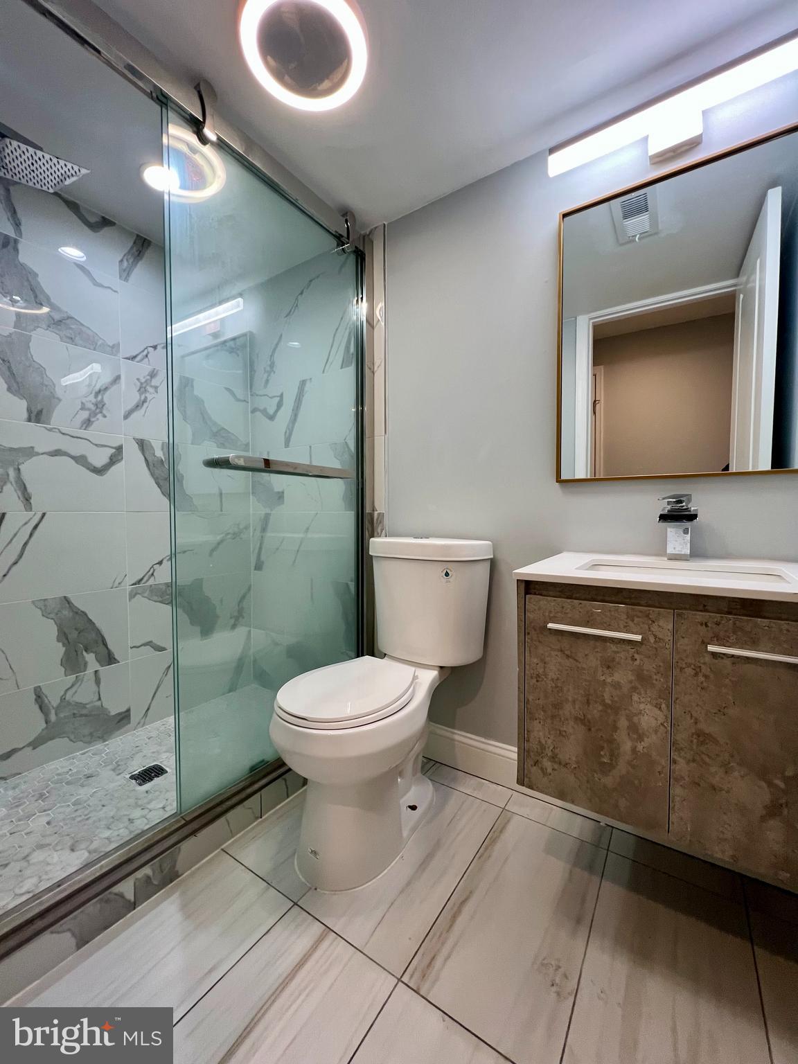 1703 South 22nd Street, Unit 1 Philadelphia, PA 19145 - Photo 23 of 27 a bathroom with a toilet sink and shower