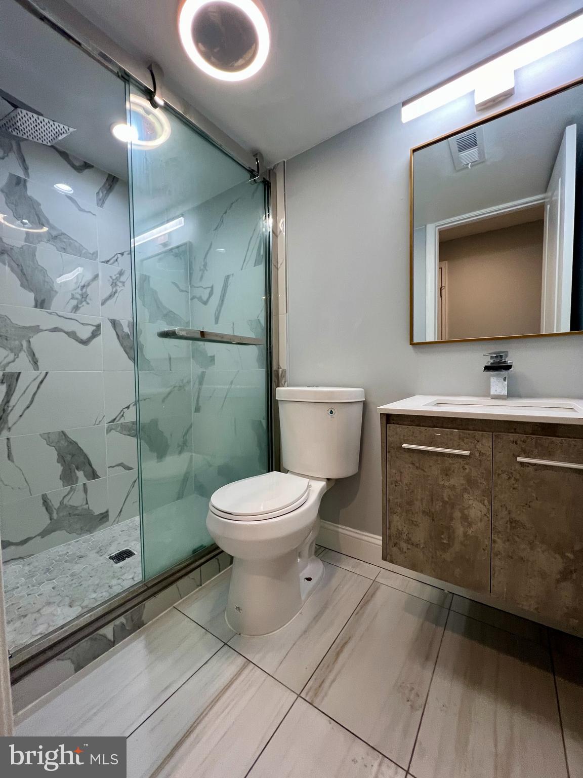 1703 South 22nd Street, Unit 1 Philadelphia, PA 19145 - Photo 24 of 27 a bathroom with a toilet sink and mirror