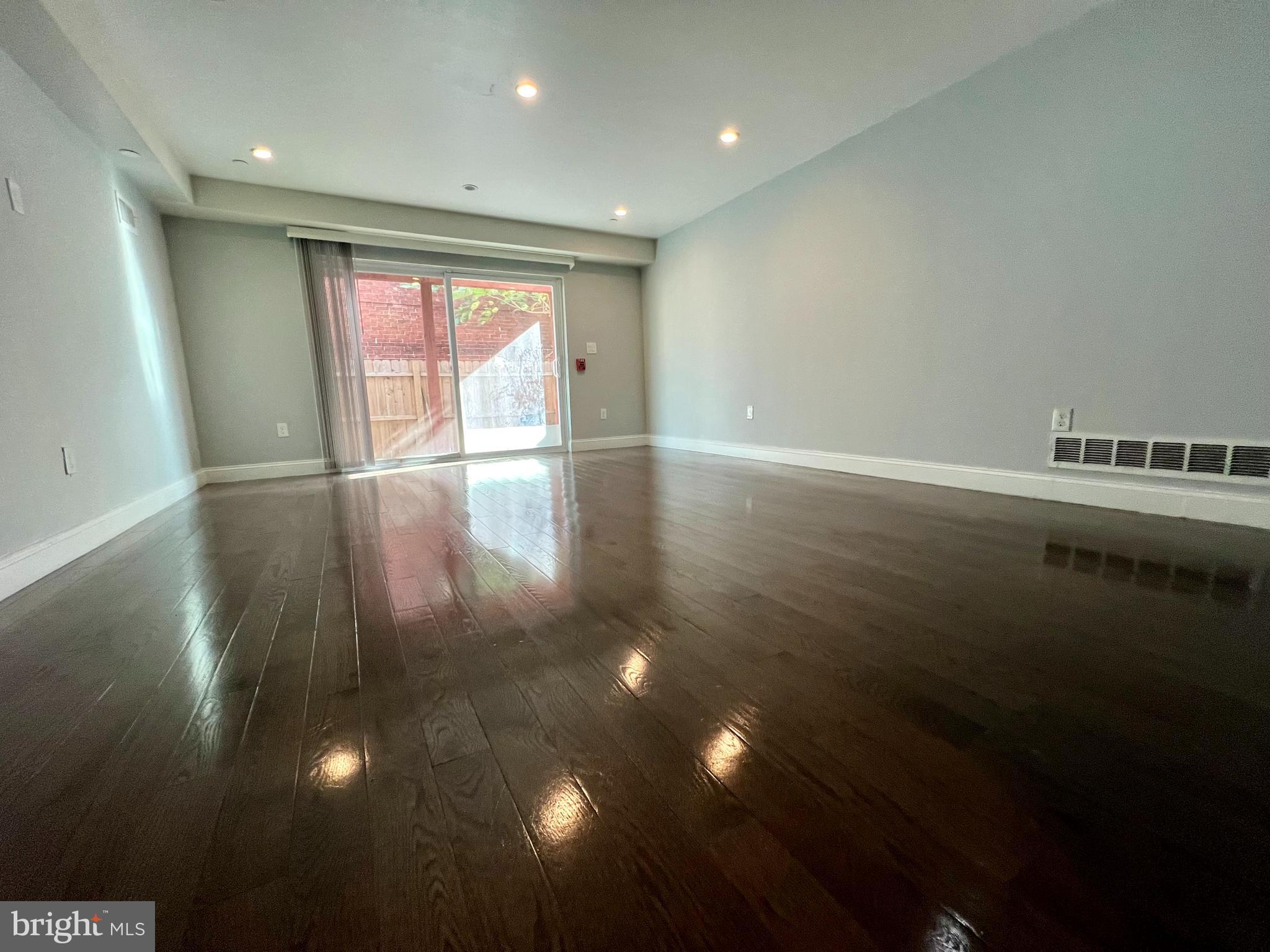 1703 South 22nd Street, Unit 1 Philadelphia, PA 19145 - Photo 3 of 27 a view of an empty room with wooden floor and a window