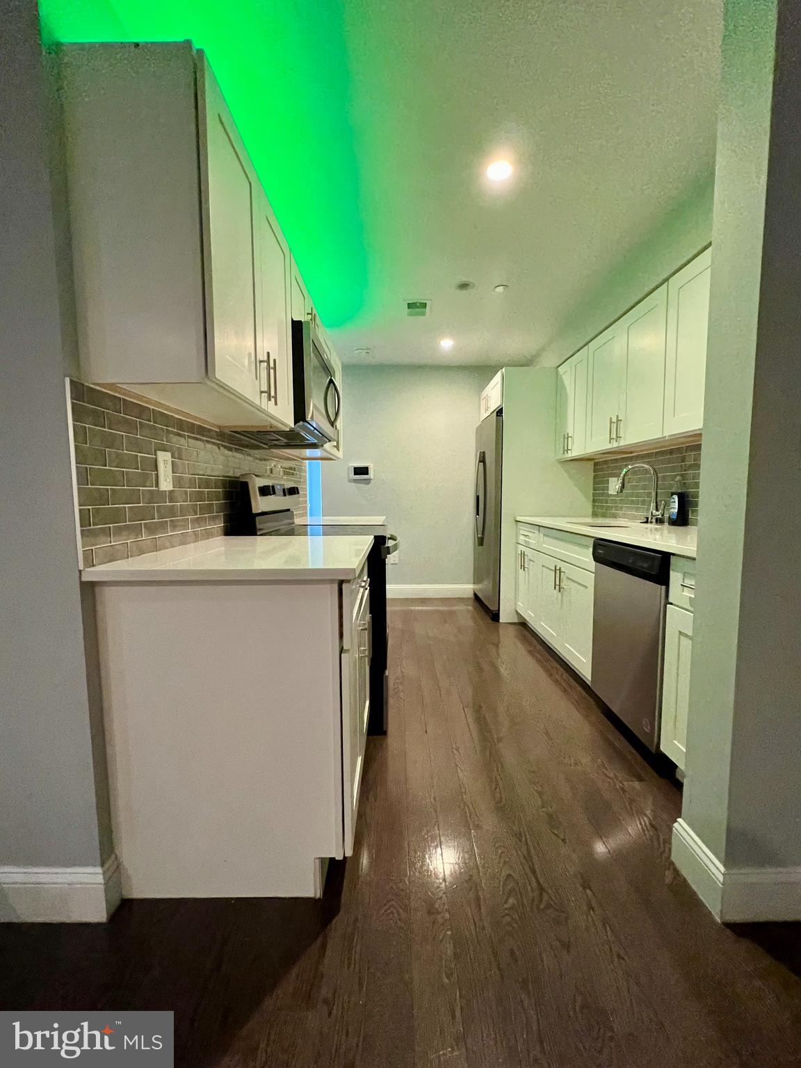 1703 South 22nd Street, Unit 1 Philadelphia, PA 19145 - Photo 7 of 27 a kitchen with stainless steel appliances a sink stove and cabinets