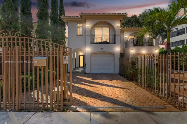 a view of a house with brick walls and plants