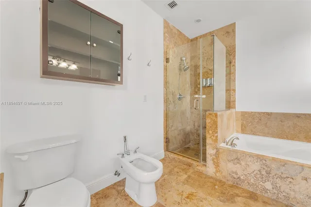 a bathroom with a toilet a sink and bathtub