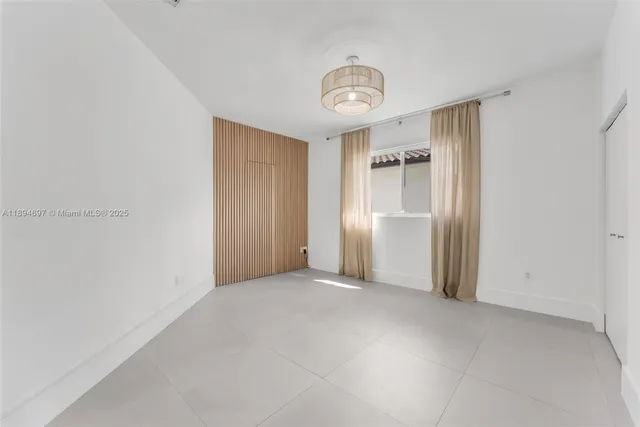 a view of an empty room and a window