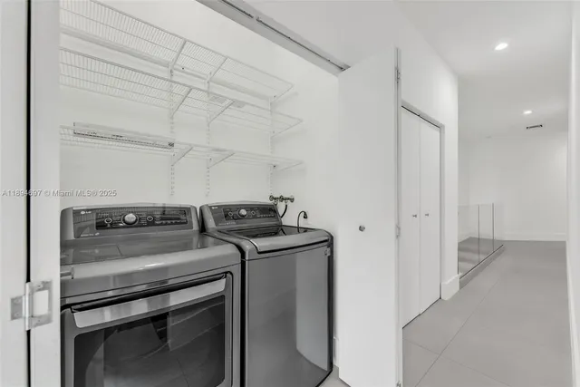 a view of storage and utility room with washer and dryer