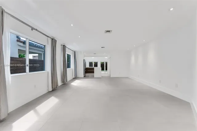 a view of empty room with a fireplace