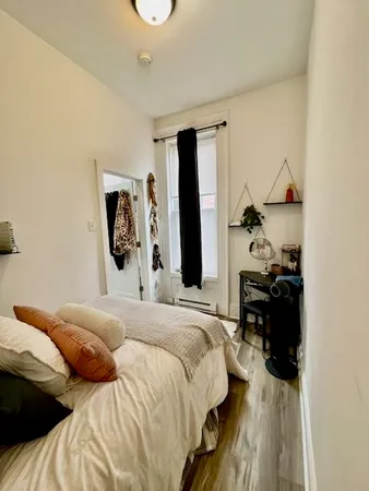 a bedroom with a bed and a dresser