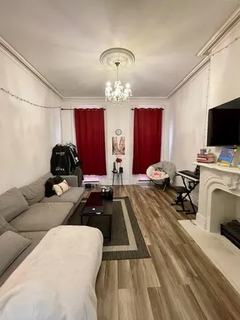 a bedroom with furniture and a chandelier