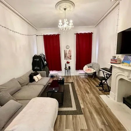 a living room with furniture a fireplace and flat screen tv