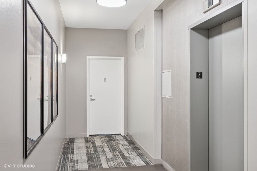 660 West Wayman Street, Unit 701 Chicago, IL 60661 - Photo 13 of 23 a view of a hallway with wooden floor and a bathroom