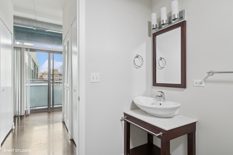 660 West Wayman Street, Unit 701 Chicago, IL 60661 - Photo 10 of 23 a bathroom with a sink a light fixture and a mirror