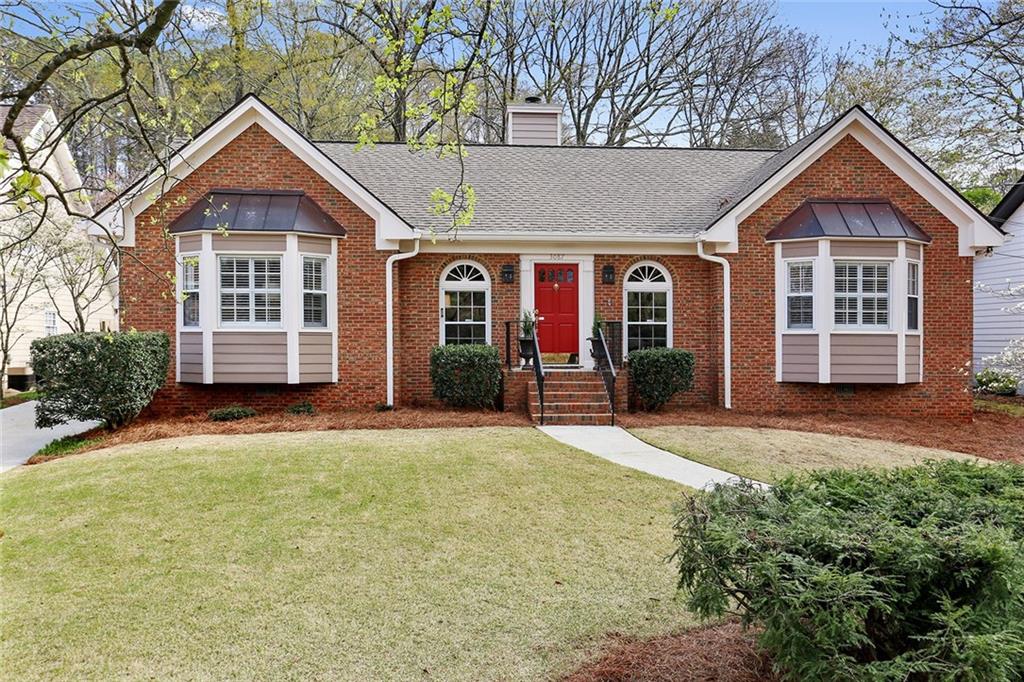 3087 Wilson Road Decatur, GA 30033 - Photo 1 of 1 a front view of a house with a yard and garage