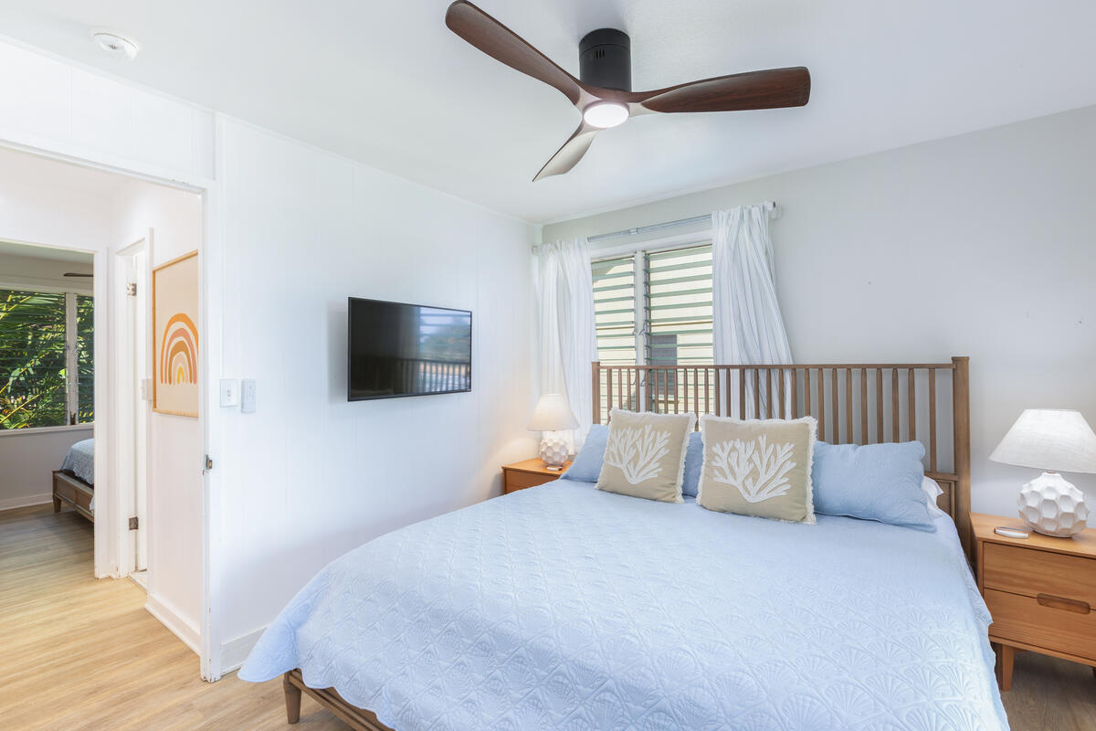 380 Papaloa Road, Unit 2 Kapaa, HI 96746 - Photo 16 of 20 a bedroom with a bed and a flat screen tv