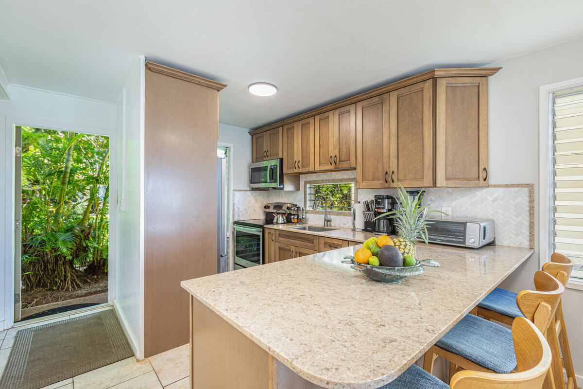 380 Papaloa Road, Unit 2 Kapaa, HI 96746 - Photo 9 of 20 a kitchen with a sink a stove and cabinets