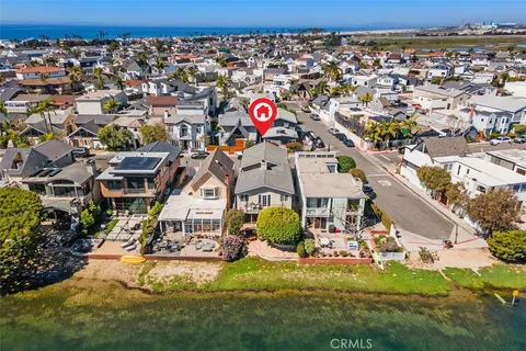 an aerial view of residential houses with outdoor space and parking