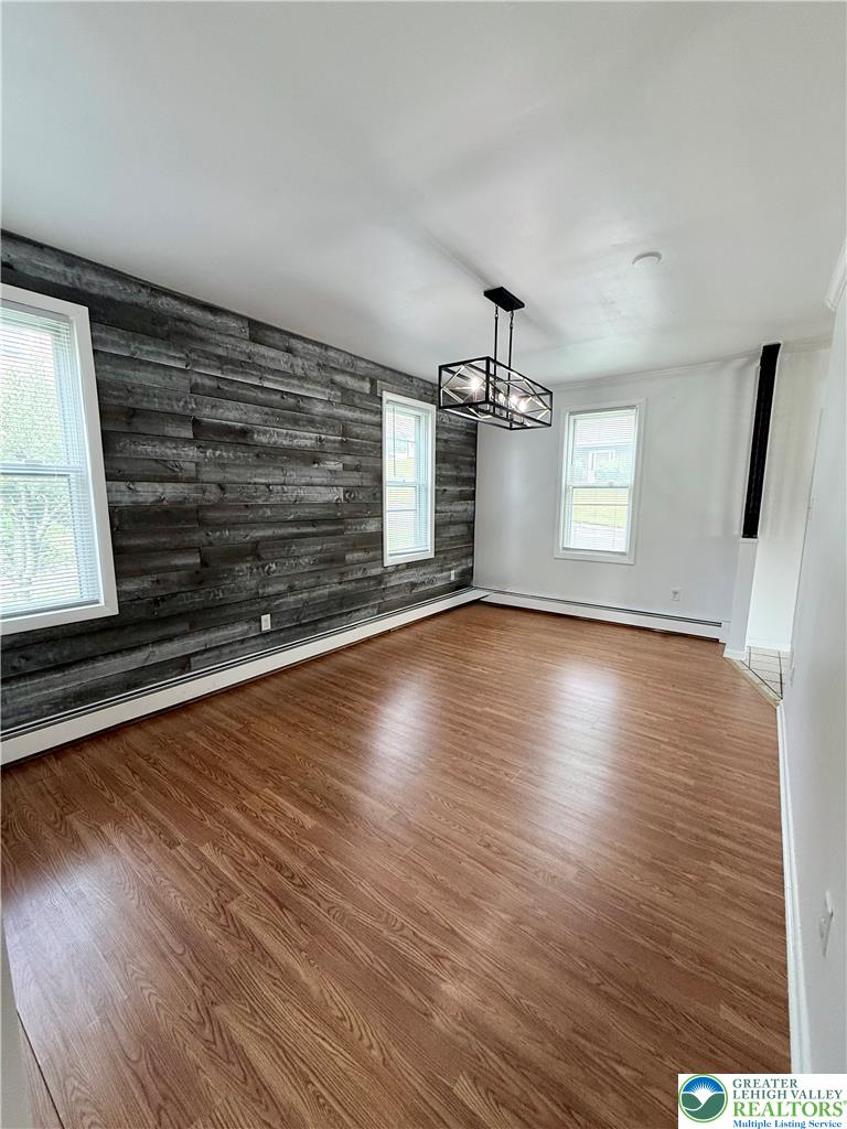 5540 Main Street Whitehall, PA 18052 - Photo 15 of 53 A well-lit interior space with rich hardwood flooring and a distinctive accent wall.
