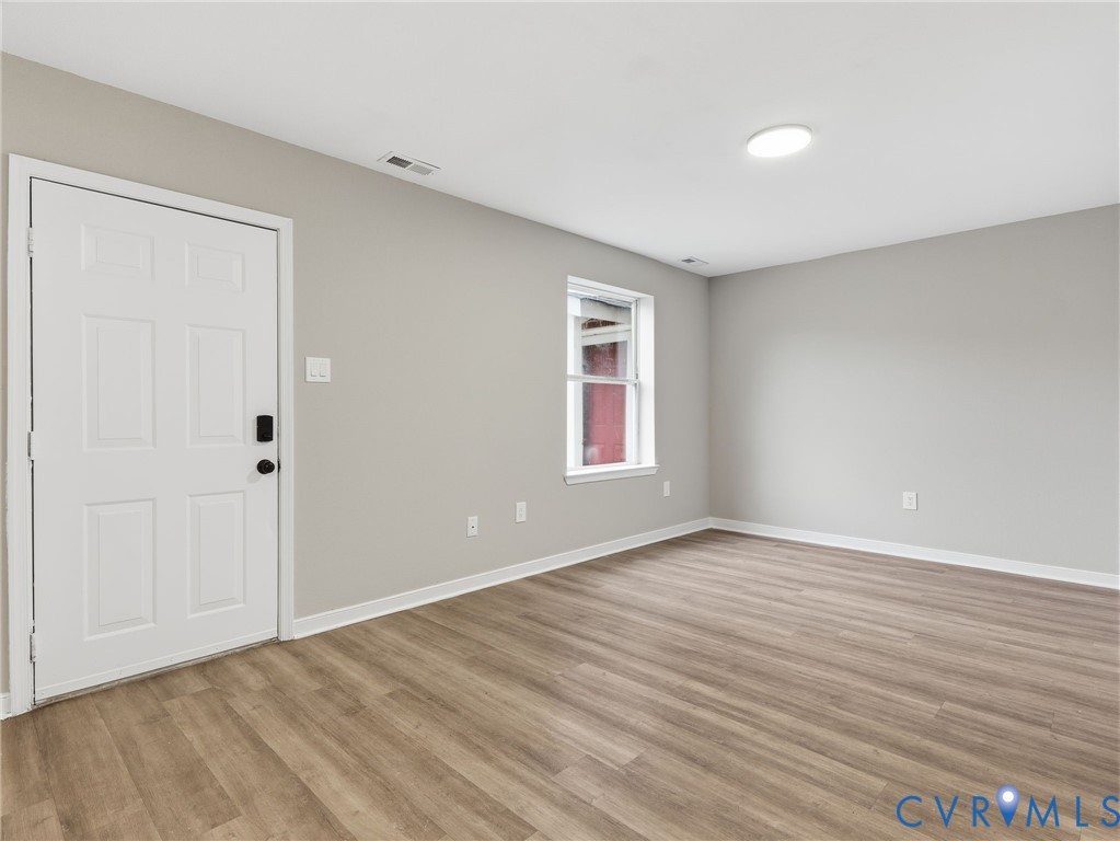 3530 East Richmond Road, Unit U15 Richmond, VA 23223 - Photo 2 of 18 a view of an empty room with wooden floor and a window