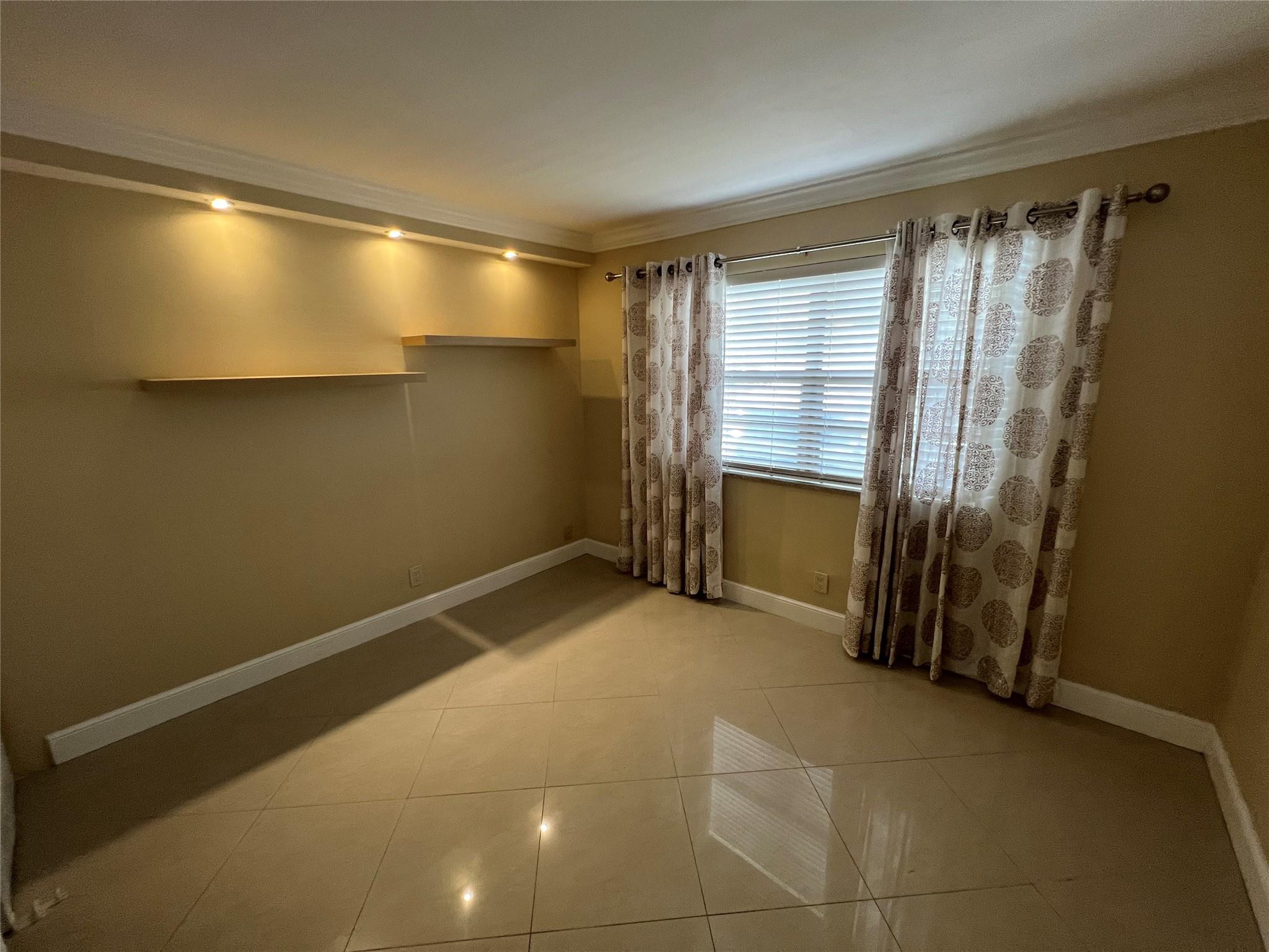 9300 Southwest 8th Street, Unit 108 Boca Raton, FL 33428 - Photo 11 of 40 a view of an empty room with a fireplace